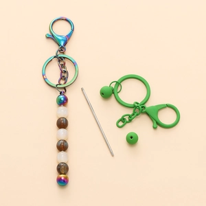 Close-up of DIY rainbow gradient metal keychain parts with colorful beads and charms