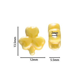Detail view of yellow clover ceramic bead showing dimensions 13.5x12mm for DIY jewelry