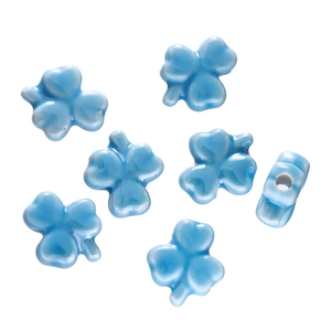Detail of sky blue clover ceramic beads showing glazed texture and precise center hole