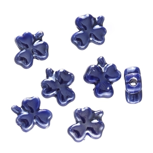 Detailed view of glossy dark blue ceramic clover beads showing 2mm center hole structure