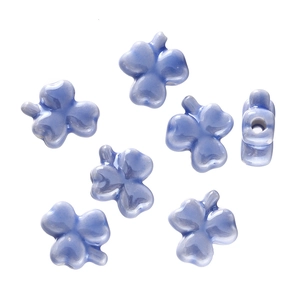Detail of light blue glazed ceramic four-leaf clover beads for DIY jewelry making