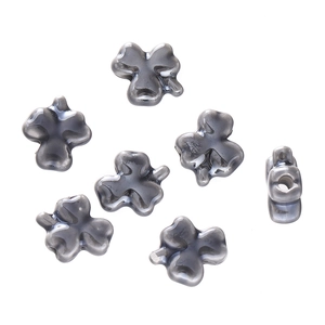 Macro view of clover-shaped ceramic beads with polished grey finish and side holes