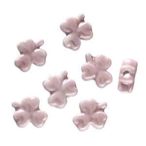 Close-up of pink clover glazed ceramic beads for DIY jewelry making and bracelet design