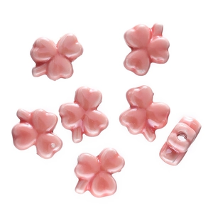 Pink clover-shaped ceramic beads with a soft pearly luster and side-drilled holes for DIY