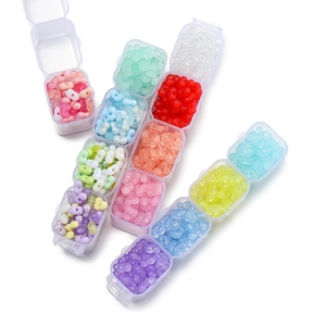Macro view of 4mm colorful acrylic peanut beads organized in a plastic storage box