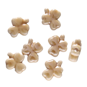 Macro view of clover-shaped milk tea resin beads with cat-eye luster for DIY jewelry making