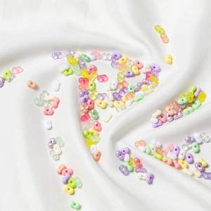 Macro shot of 4mm acrylic peanut beads in macaron and jelly colors for DIY jewelry