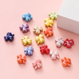Detailed view of colorful clover ceramic beads for DIY jewelry making with smooth finish