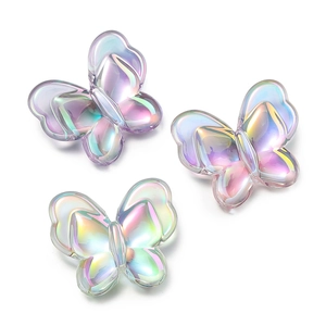 Macro shot of 22mm iridescent acrylic butterfly beads with aurora gradient for DIY jewelry