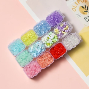 Macro view of 12-grid organizer box filled with 4mm colorful acrylic peanut beads for DIY