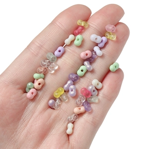 Macro detail of 4mm acrylic peanut beads in macaron colors for DIY jewelry making