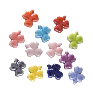 Macro shot of twelve colorful clover-shaped resin hair clips in vibrant macaron shades