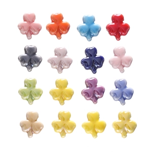 Detailed view of colorful four-leaf clover ceramic beads in 16 assorted glossy colors