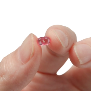 Macro shot of a 4mm pink translucent peanut bead for DIY jewelry making material