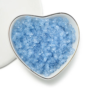 Light blue translucent 4mm acrylic peanut beads displayed in a white ceramic heart bowl