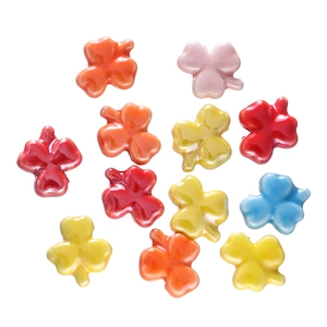 Detailed view of colorful clover-shaped ceramic beads for DIY necklace and bracelet jewelry