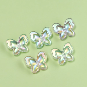 Macro detail of iridescent butterfly acrylic beads with colorful Aurora UV coating