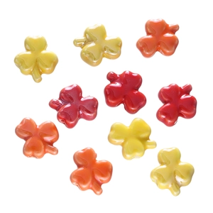 Detailed view of colorful clover-shaped ceramic beads for DIY jewelry making and crafts