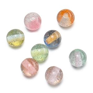 Macro detail of 10mm dual-tone resin beads with silver glitter for DIY jewelry making