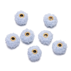 Detailed macro view of 18mm light blue teddy fleece beads with gold metal grommet centers