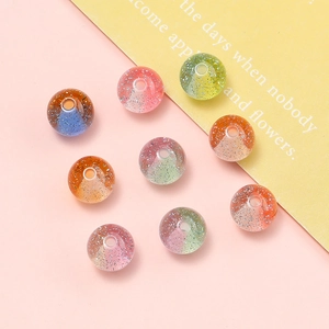 Macro shot of 10mm glitter resin beads with dual-tone gradients for DIY jewelry projects