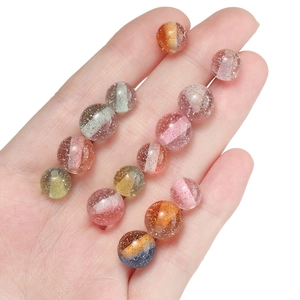 Macro shot of 10mm glitter resin beads with dual-color stripes for DIY jewelry