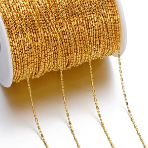 Close-up of 1.5mm golden ball chain on spool for DIY jewelry making and tassels