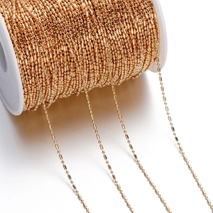 Detail of 1.5mm gold beaded bamboo chain on white spool for DIY jewelry making