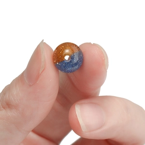 Detail of 10mm resin bead with dual-color blue and gold glitter for DIY jewelry making