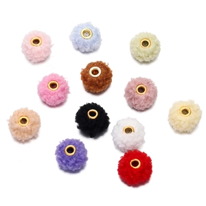 Macro shot of 18mm colorful teddy fleece beads with golden eyelets for DIY crafts