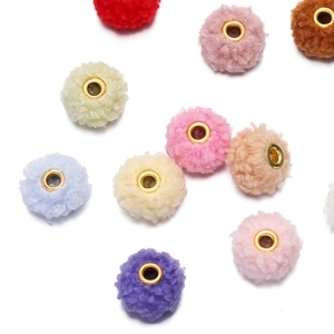 Macro detail of 18mm colorful teddy plush beads with golden metal eyelet for DIY jewelry