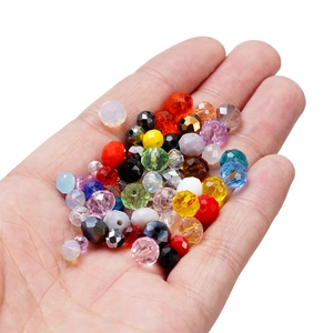 Close-up of colorful faceted crystal beads held in hand for DIY jewelry making