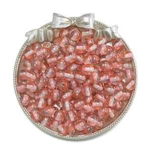 Macro detail of 10mm resin glitter beads with two-tone pink and white stripe for DIY jewelry