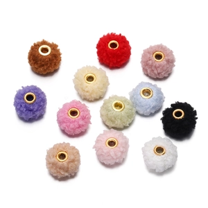 Macro detail of 18mm teddy velvet plush beads with gold metal eyelets for DIY jewelry
