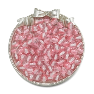 Macro shot of 10mm pink and white striped resin beads with fine glitter in silver tray