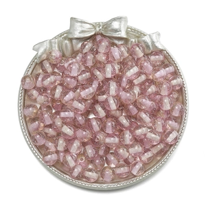 Macro shot of 10mm pink glitter resin beads with white stripe core in vintage silver tray