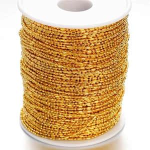 Detailed view of 1.5mm golden ball chain on spool for DIY jewelry making and tassels