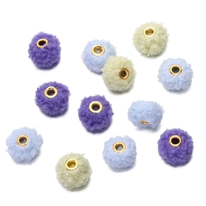 Macro shot of 18mm curly teddy plush beads in purple and blue with gold metal holes