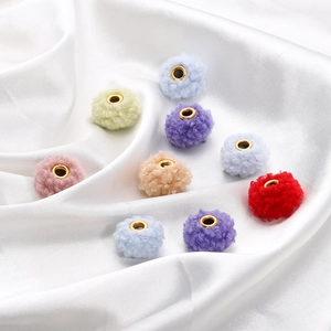 Close-up of 18mm colorful teddy plush beads with gold metal centers for DIY jewelry making