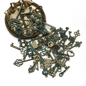 Dettaglio di ciondoli a forma di chiavi vintage in lega con finitura bronzo e patina verde