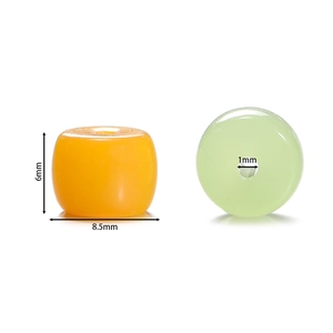 Detailed size view of orange and green cylinder glass beads for DIY jewelry making