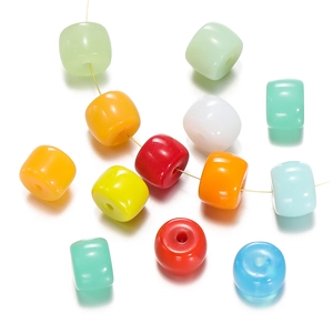 Macro shot of colorful cylindrical glass beads with smooth holes for DIY jewelry making