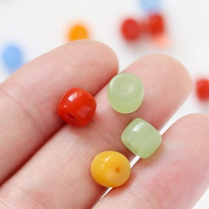 Colorful cylindrical glass beads for DIY bracelets and necklaces in red, green and orange