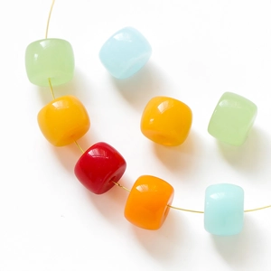 DIY colorful cylinder glass beads in red, orange, and blue on gold wire for jewelry