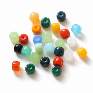 Detailed view of colorful polished cylinder glass beads for DIY jewelry making