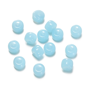 Macro detail of light blue translucent glass cylinder beads for DIY jewelry making