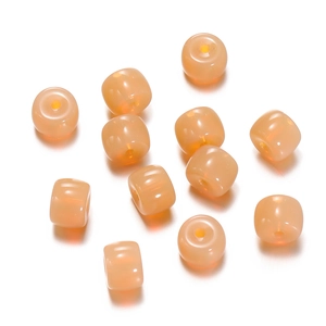 Macro detail of translucent pale pink cylindrical glass beads for DIY jewelry making