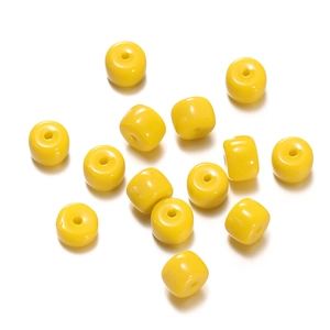 Macro detail of yellow cylindrical glass spacer beads for DIY jewelry making