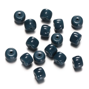 Macro shot of glossy dark teal cylindrical glass beads for DIY jewelry making