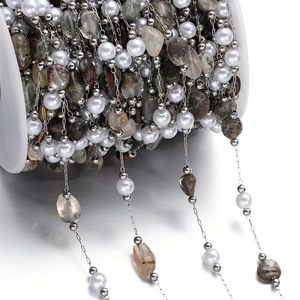 Detailed close-up of stainless steel chain with faux pearls and colorful natural stone chips
